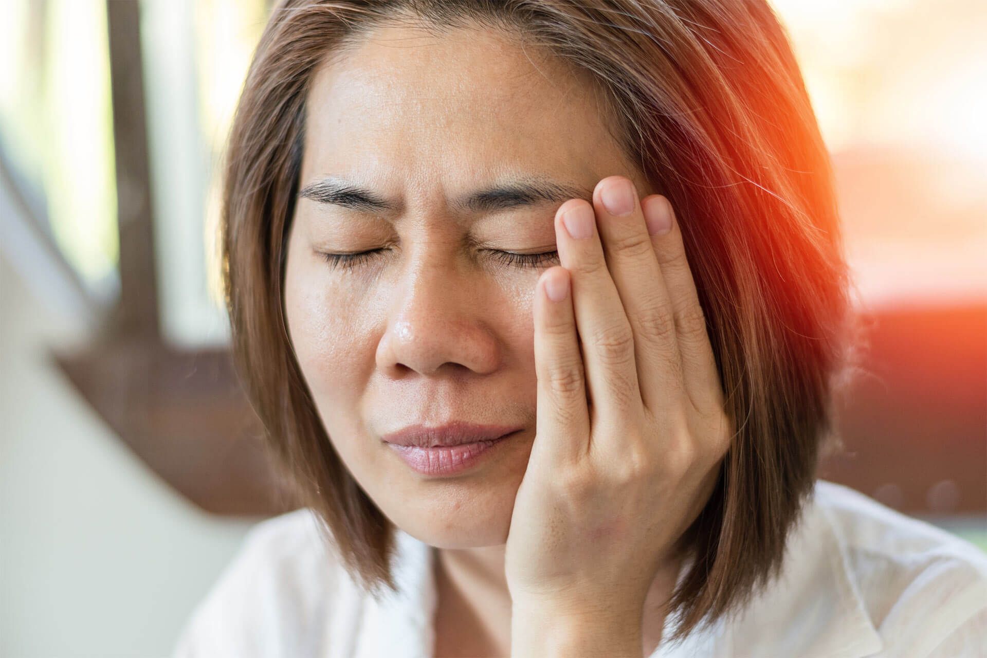 woman hand on cheek face as suffering from facial pain, mumps or toothache